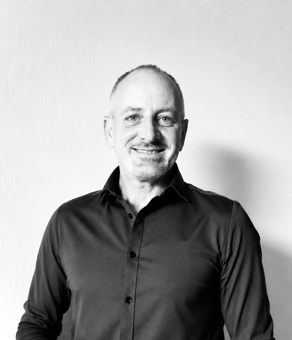 Black-and-white portrait of Alex Hasbun, founder and project director of HASBUN Consulting